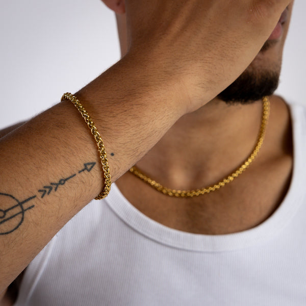 5mm gold wheat bracelet and matching necklace worn with a white tank top, close-up view