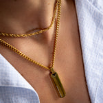 3mm gold rope chain and 4mm gold Cuban totem pendant layered around the neck, close-up view