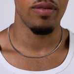 4mm silver curb chain necklace worn around the neck, front close-up