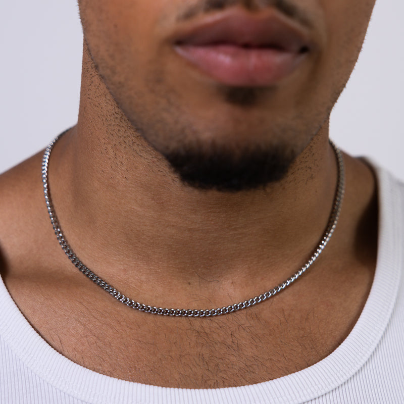 4mm silver curb chain necklace worn around the neck, front close-up
