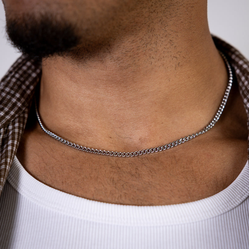 4mm silver curb chain necklace worn around the neck, front close-up