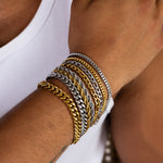 5mm gold and silver assorted chain bracelets worn on the wrist, close-up view