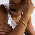 5mm gold wheat chain necklace worn around the neck whilst weaing white vest, matching 5mm wheat bracelet in view. 