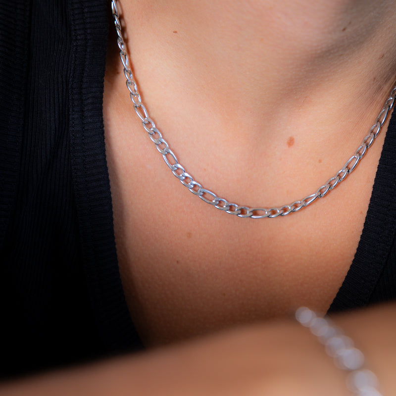 Figaro chain silver 5mm side shot, wearing black vest