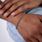 5mm silver wheat chain bracelet worn on the wrist, close-up view