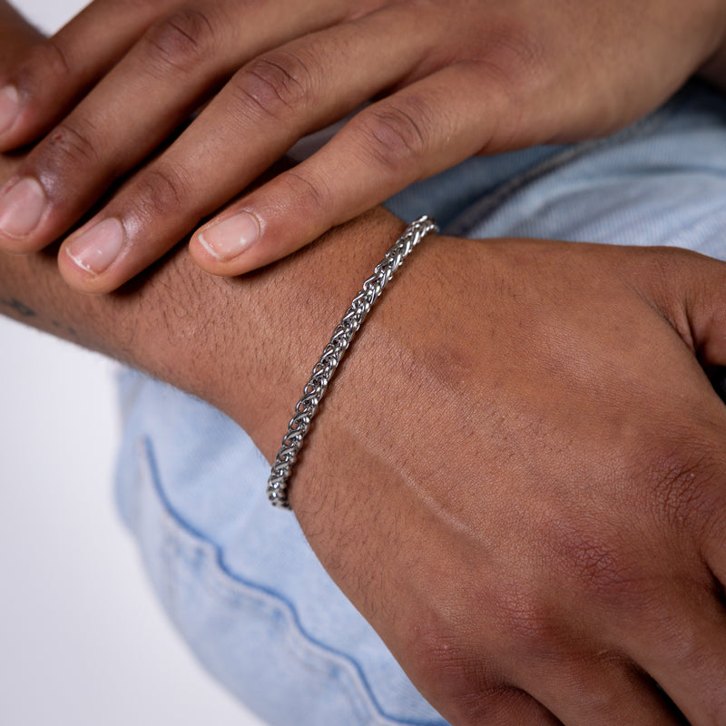 5mm silver wheat chain bracelet worn on the wrist, close-up view