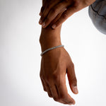 5mm silver wheat chain bracelet worn on the wrist, close-up view