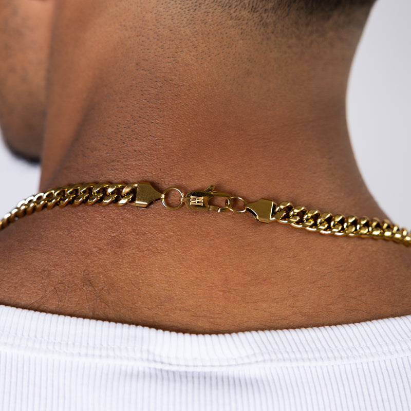 Close-up back view of an 8mm gold Cuban chain clasp necklace worn around the neck
