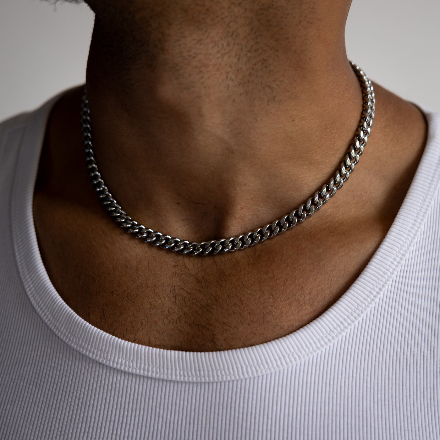 8mm silver cuban chain necklace worn around the neck, front close-up