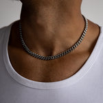 8mm silver cuban chain necklace worn around the neck, front close-up