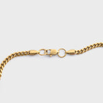 Gold chain  on a light grey background