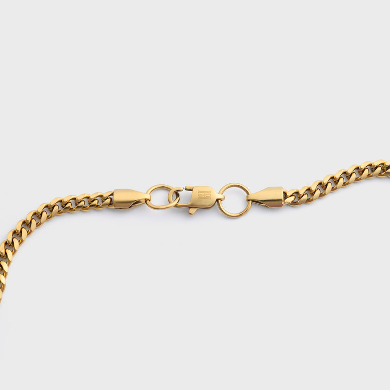 Gold chain  on a light grey background