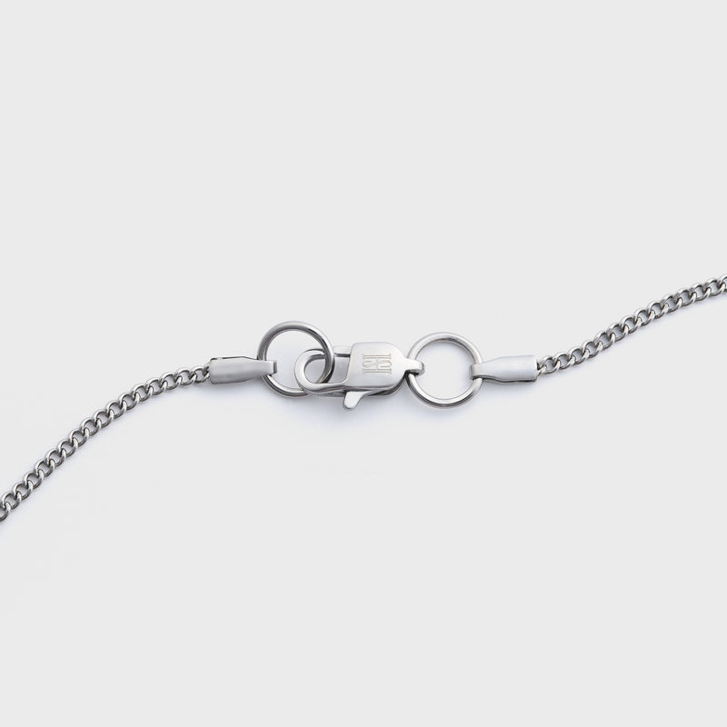 Curb chain silver 2mm clasp shot on light grey background