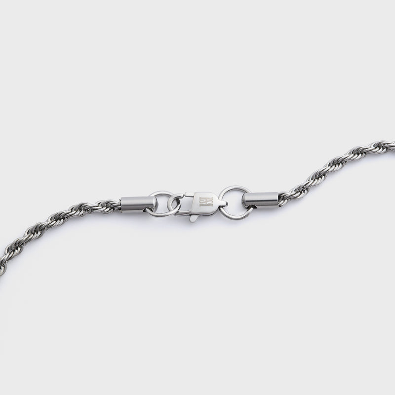 Silver rope chain clasp shot on a light grey background