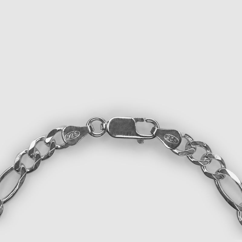 Silver bracelet on a light grey background