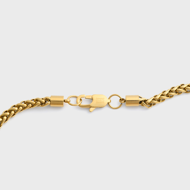 Wheat chain gold 5mm clasp shot on light grey background