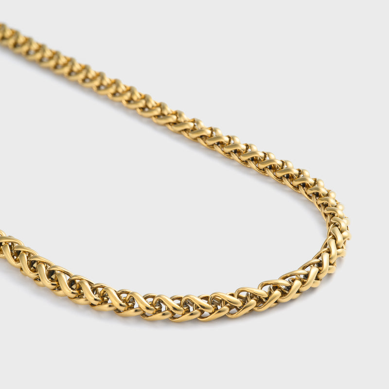 Wheat chain gold 5mm side shot on light grey background