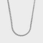 Silver wheat chain necklace on a light grey background